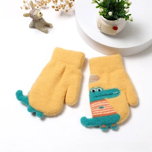Detail of yellow knitted toddler mittens featuring cute cartoon crocodile and soft texture