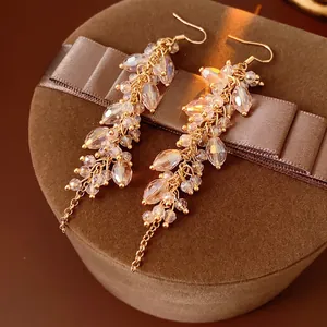 Bohemian iridescent crystal fringe drop earrings with gold chains on velvet