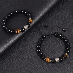 Men's 10mm black obsidian and tiger eye bead bracelet set on black leather texture