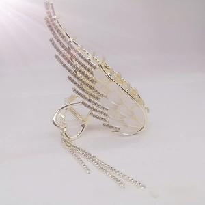 Detailed close-up of angel wing hair claw with rhinestones and elegant long tassels
