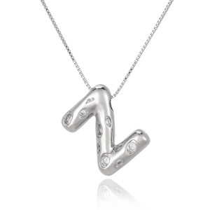 Macro detail of silver bubble letter Z pendant necklace with sparkling zircon stones