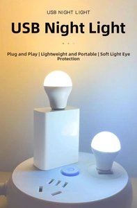 Close-up of portable white USB ball night lights plugged into a power bank for eye care