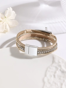 Detail view of multi-layer beige leather and gold mesh bracelet with crystal inlays