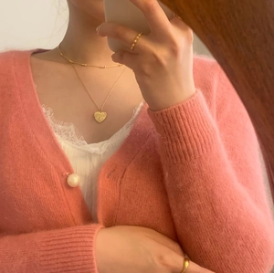 On-body view of a gold 925 silver heart pendant necklace with beaded accent rings