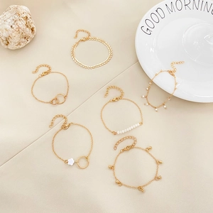 Set di 6 bracciali bohémien dorati con perle e ciondoli a foglia su tessuto