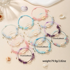 Detailed view of colorful shell and gravel woven bracelets with summer beach vibe