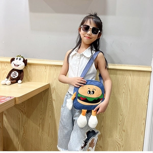 Cartoon burger shaped crossbody canvas bag shown on a young girl in a cozy setting