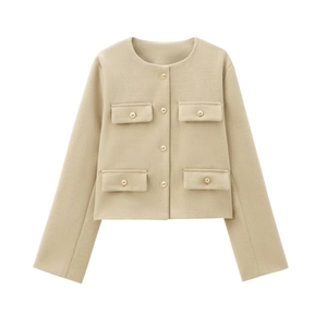 Detail of beige knit jacket featuring textured weave and golden cylindrical buttons
