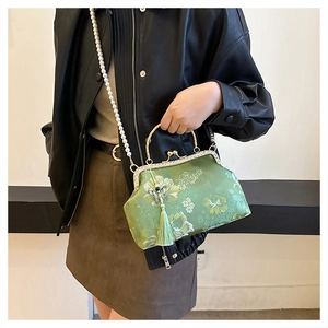 Green jacquard shell bag with pearl strap, bow tassel, and vintage metal frame clasp