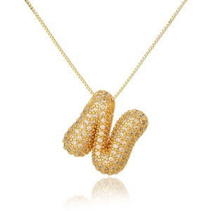 Macro view of gold letter N pendant with sparkling micro-pave crystals and polished box chain
