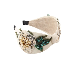 Elegant wide headband with floral embroidery and rhinestones on cream fabric