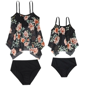 Detail view of mother and daughter matching two-piece tankini sets with mesh floral overlays