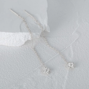 Macro view of S925 silver four-leaf clover tassel earrings with cubic zirconia