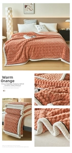 Detailed view of warm orange dual-sided fleece blanket with soft textured pineapple pattern