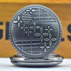 Detailed close-up of antique silver pocket watch with embossed vintage floral patterns