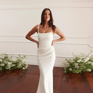 Detail of white satin evening dress featuring elegant waist pleats and slim fishtail cut