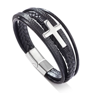 Detail of multi-layer black braided leather bracelet with silver cross and magnetic clasp