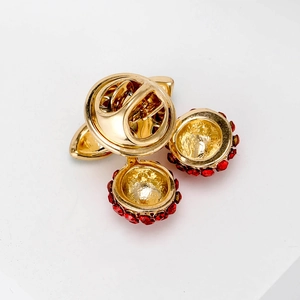Elegant gold cherry stud earrings with vibrant red rhinestones and polished finish