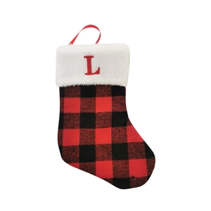 Detail of red and black plaid Christmas stocking with white faux fur and red letter L