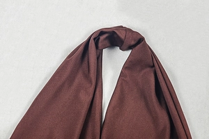Close-up of deep brown halter neck strap detail on a backless bodycon maxi dress