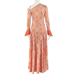 Detail of asymmetric neckline and orange geometric leaf print on long sleeve dress