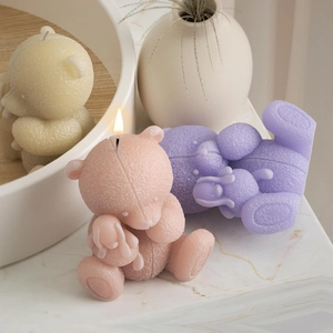 Teddy bear candles in pastel pink and purple with soft textured finish and burning wick