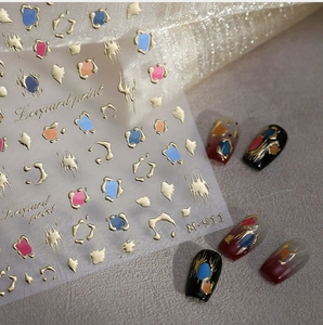 Macro detail of M-911 nail art stickers featuring golden leopard print and abstract ink