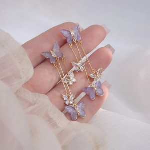 Elegant purple butterfly long tassel earrings in gold metal with sparkling crystals