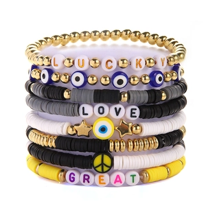Detail of colorful polymer clay bead bracelets with Lucky and Love letter charms