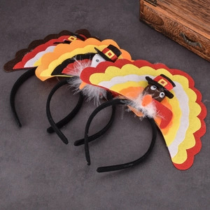Three Thanksgiving turkey headbands with colorful felt feathers on a dark textured surface