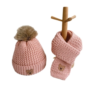 Pink knit baby hat and scarf set with cozy faux fur pompom and cute bear patches