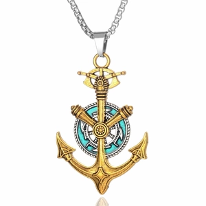 Macro shot of anchor and helm pendant with turquoise detail on vintage chain