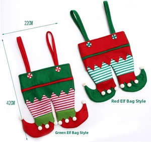 Detail view of red and green Christmas elf candy bags with striped legs and soft felt texture