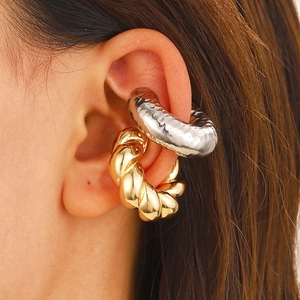 Minimalist gold and silver hollow tube ear cuffs with textured metal finishes on model