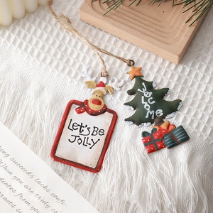 Nordic Christmas metal ornaments with reindeer and tree designs on a rustic wooden tray