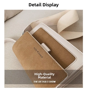 Detail shot of a matte square crossbody bag with contrast leather and logo print
