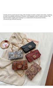 Close-up of snake skin textured flap bags with gold rings and metal chain straps