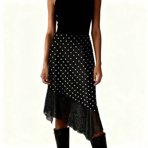 Detail showing the intricate black lace patchwork on a polka dot midi skirt hemline