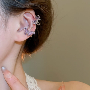 Detail of purple zircon butterfly ear cuff on ear with gold metal outlines and crystals