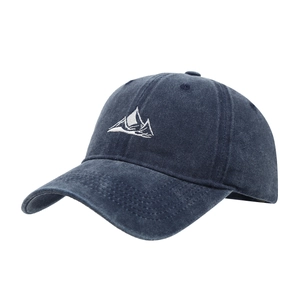 Navy blue washed cotton baseball cap with white mountain embroidery shown in a side view