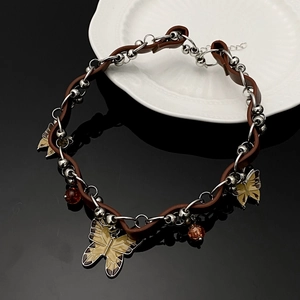 Y2K punk style choker with brown leather cord, metal chains and brown butterfly pendants