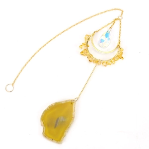 Detailed close-up of yellow agate slice wind chime with golden chain and crystal drop