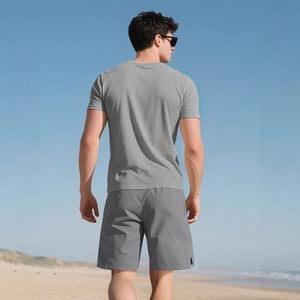 Men's light grey heavy ribbed cotton Henley T-shirt with shorts outdoors on the beach