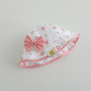 Chapeau de soleil blanc pour bébé avec nœud rose et imprimés de beignets
