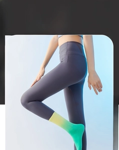 Close-up of non-slip grip dots on yellow-green gradient compression yoga socks