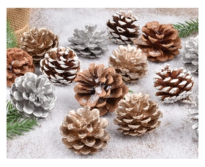Detail of pine cones in gold, silver and natural finishes on a festive snowy background