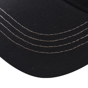 Detail of classic black baseball cap brim with four rows of professional stitching