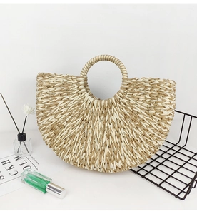 Detailed shot of bicolor paper rope woven beach tote with round handle on white background