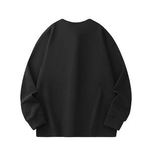 Detail view of the black waffle knit texture and ribbed hem on the back of the sweatshirt