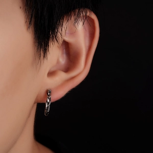 Retro titanium steel twisted hoop earring in vintage silver finish on male model